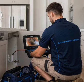 Clearing a blocked sink at a Ryde property